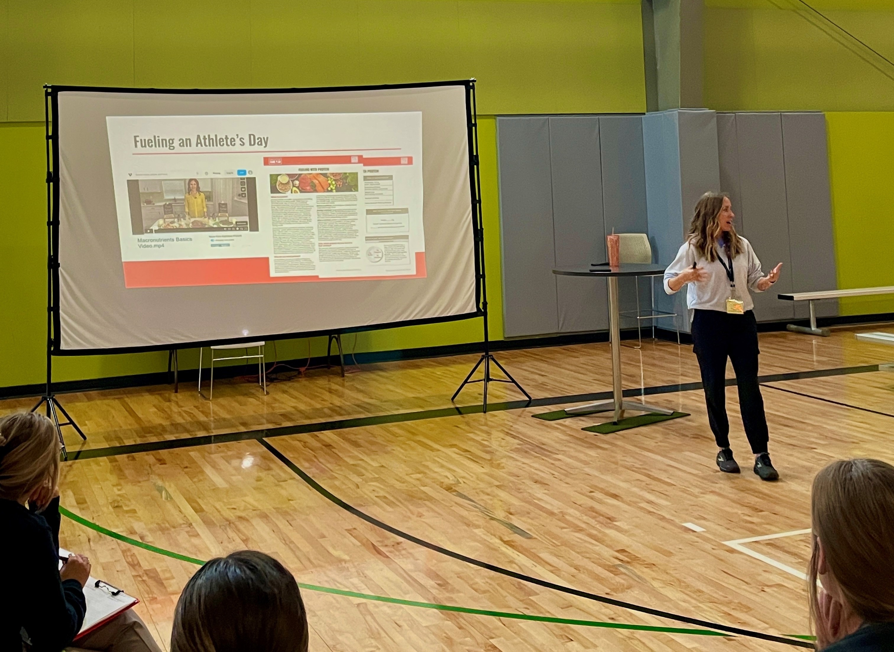 a9f6b57c-0305-f667-87e8-2351eb5da1a5.jpg Abby Heidari presenting to kansas coaches about sports nutrition game plan