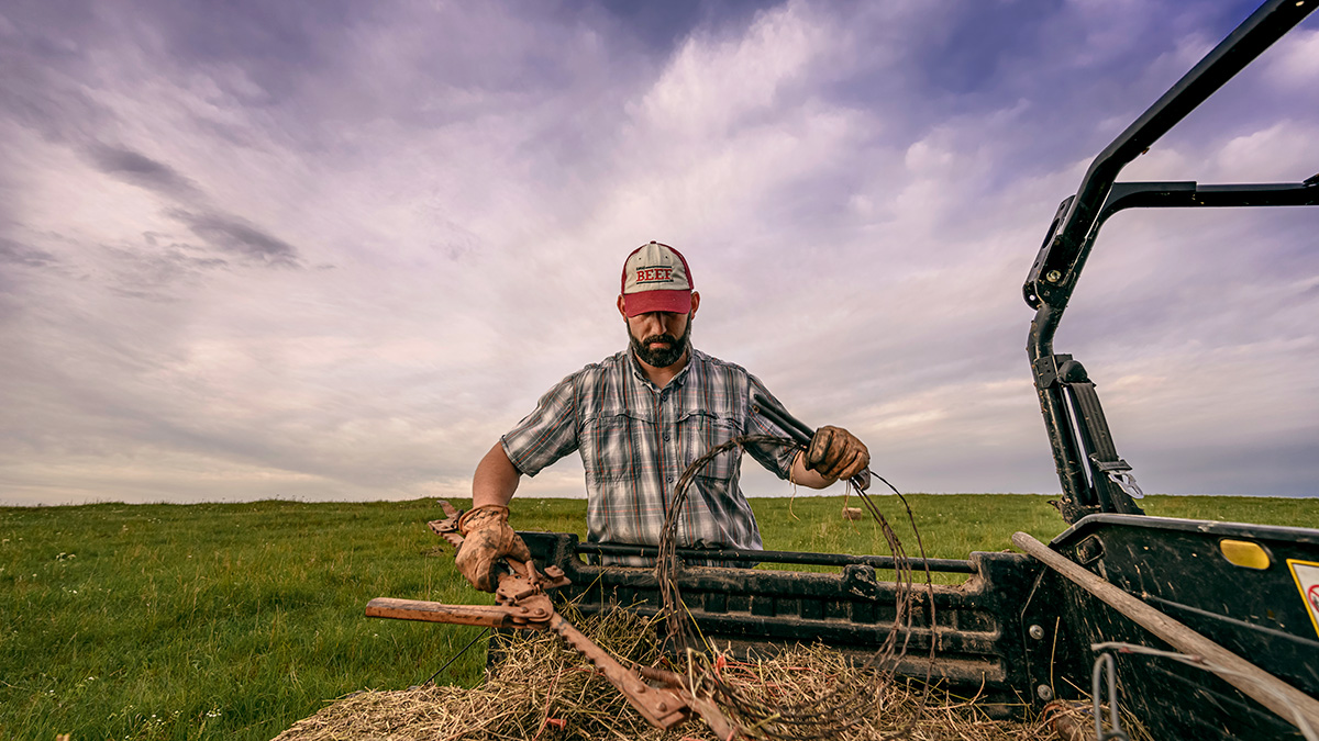 Farmer Fixing Fence